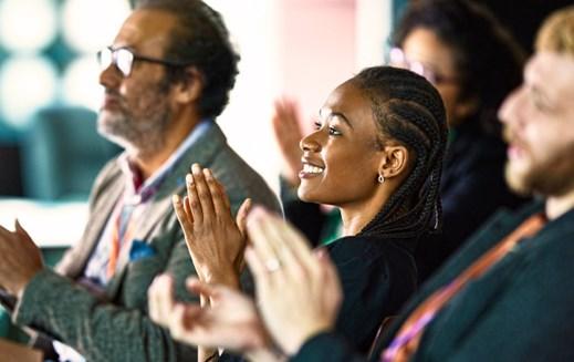 Audience applauding at conference