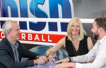 Three employees sitting round a table in the Finish office 